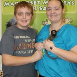 Mother and son holding a Marmoset Monkey